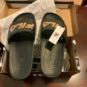 Flip flop by Fila. Black with gold logo.